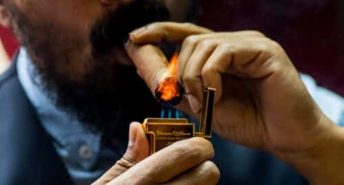 man lighting tobacco